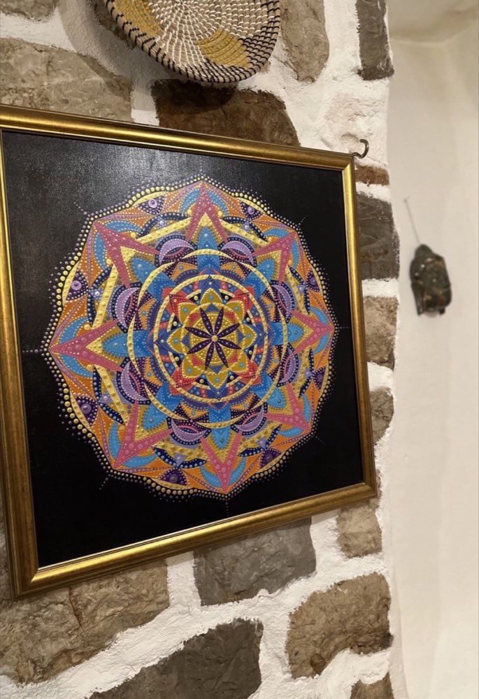 The Unity Mandala displayed on a stone wall